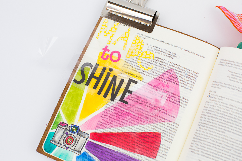 Amy Bruce is sharing with us her step by step process in creating this mixed media art journaling Bible page about being made to shine in His image