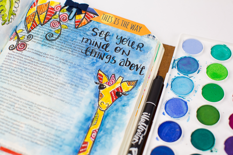 Amy Bruce shows how to add this adorable giraffe illustration to her Journaling Bible and shares the need to focus on things above